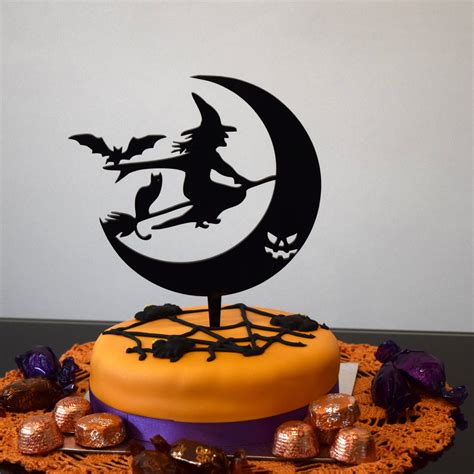 Carrying a little magic witch cake topper
